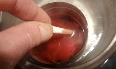dipping wrapped match in wax